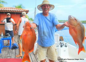 Placencia Belize man holding fish he caught – Best Places In The World To Retire – International Living
